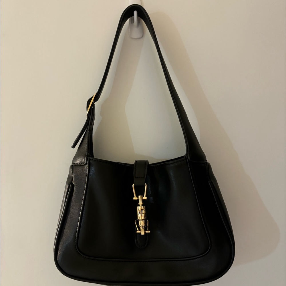 black shoulder bag with gold clasp